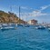 Small pleasure boats docked in the waters near a circular art deco building